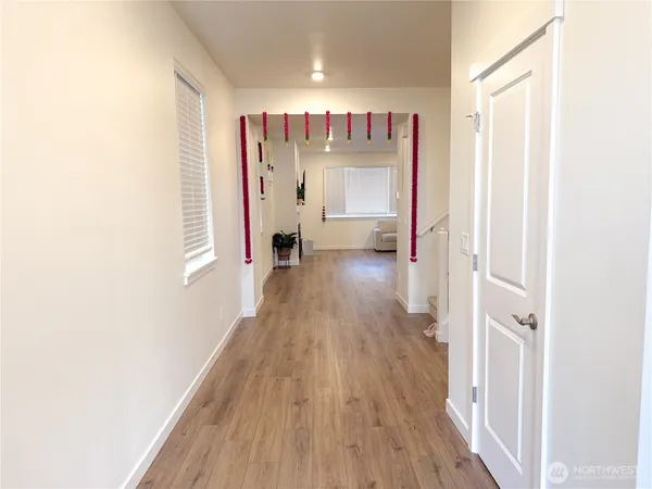 a view of a hallway with wooden floor
