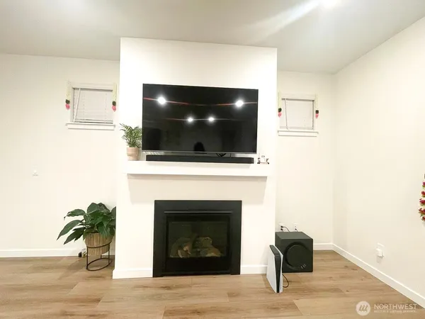 a living room with a fireplace and a flat screen tv