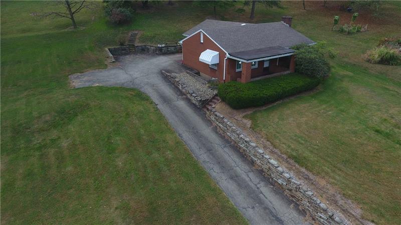 Driveway leads to attached garage with additional parking spaces... 