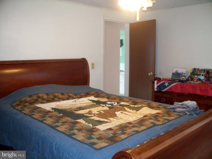 3932 Highland Ridge Road Berkeley Springs, WV 25411 - Photo 14 of 30 a bedroom with a bed and a dresser