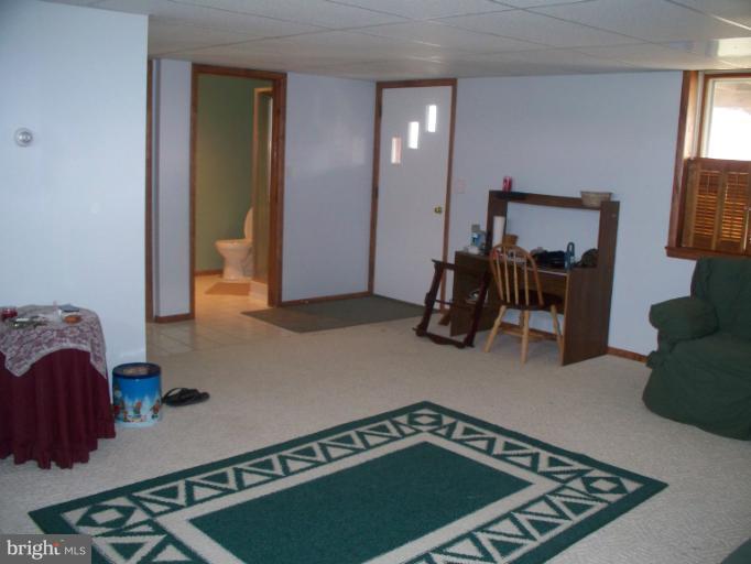 3932 Highland Ridge Road Berkeley Springs, WV 25411 - Photo 19 of 30 a room with furniture and a mirror