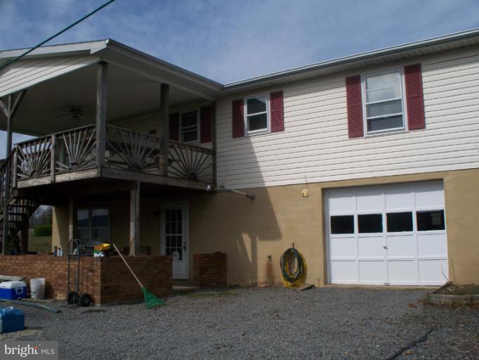 3932 Highland Ridge Road Berkeley Springs, WV 25411 - Photo 22 of 30 a view of a house with a space and porch