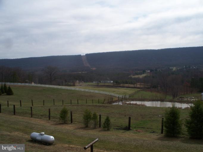 3932 Highland Ridge Road Berkeley Springs, WV 25411 - Photo 25 of 30 a view of a lake with a mountain