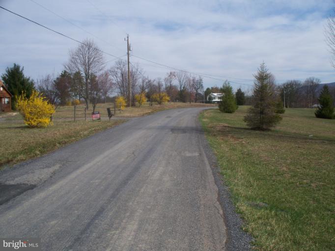 3932 Highland Ridge Road Berkeley Springs, WV 25411 - Photo 27 of 30 a view of a city street next to a yard