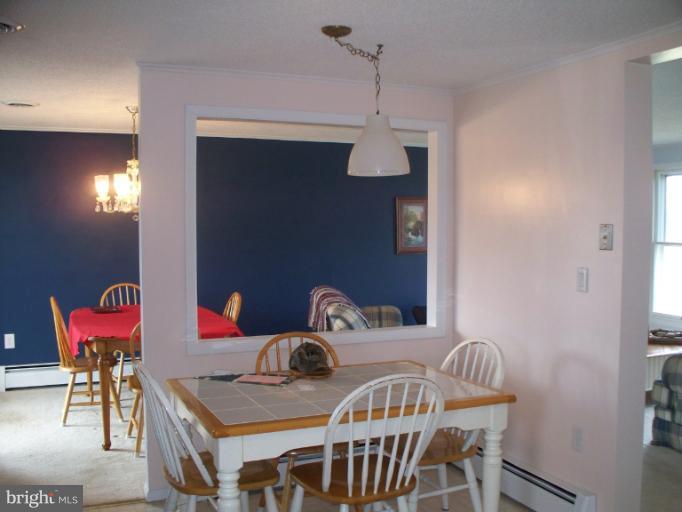 3932 Highland Ridge Road Berkeley Springs, WV 25411 - Photo 5 of 30 a view of a dining room that has a table and chairs