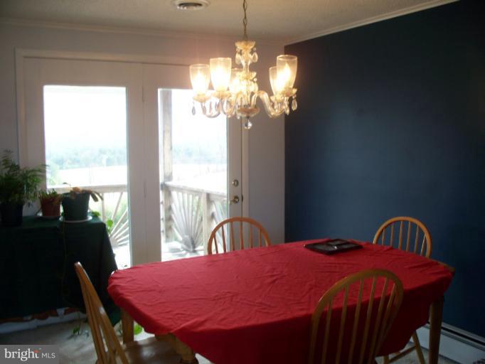 3932 Highland Ridge Road Berkeley Springs, WV 25411 - Photo 6 of 30 a view of a dining room with furniture window and outside view