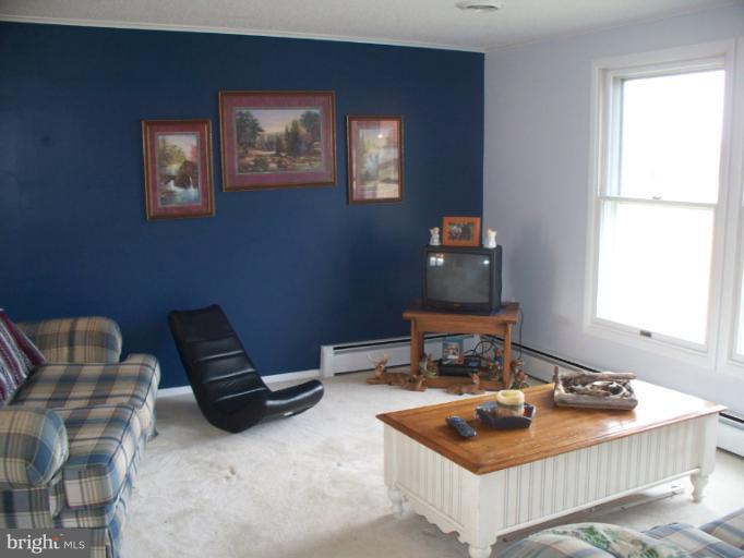 3932 Highland Ridge Road Berkeley Springs, WV 25411 - Photo 9 of 30 a living room with furniture and a window
