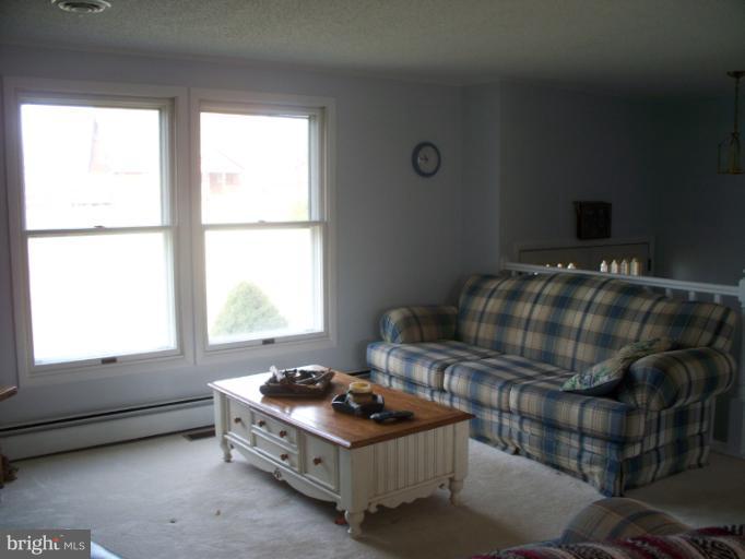 3932 Highland Ridge Road Berkeley Springs, WV 25411 - Photo 10 of 30 a bedroom with a bed and window