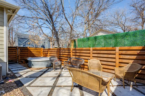 a backyard of a house with barbeque oven table and chairs