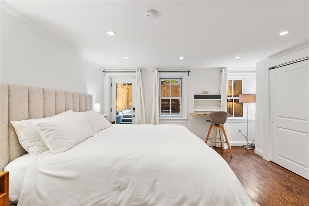 81 Appleton Street, Unit 1 Boston, MA 02116 - Photo 16 of 35 a spacious bedroom with a large bed and a table