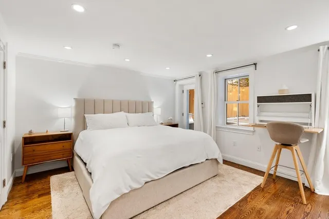 a bedroom with a bed and a view of living room