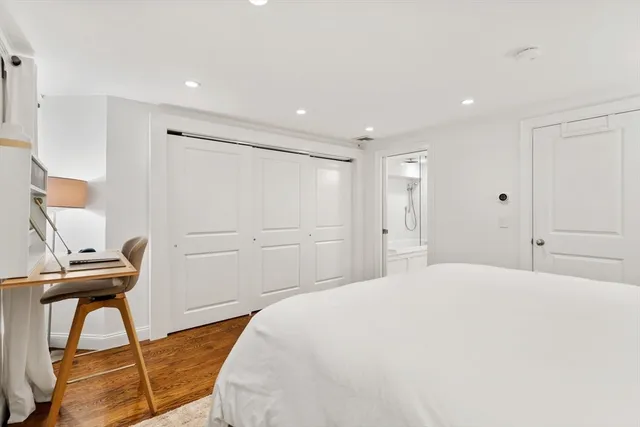 a bedroom with a bed and a desk