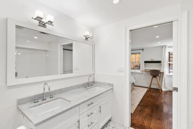a spacious bathroom with a sink double vanity and a mirror