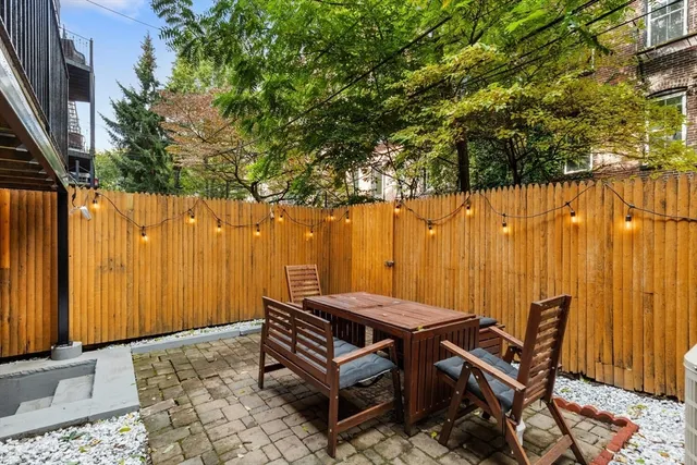 an outdoor sitting area with a table chair