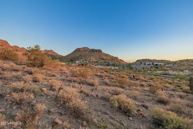 a view of a large mountain with mountains in the background