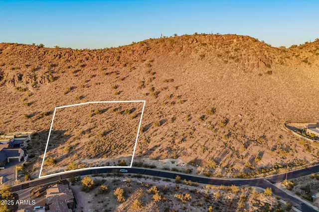 a view of a large mountain with mountains in the background