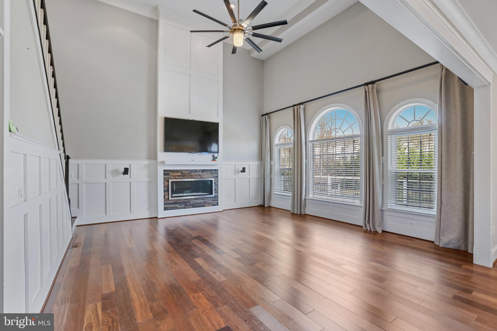 21490 Cedar Drive Sterling, VA 20164 - Photo 19 of 73 a view of a livingroom with wooden floor a ceiling fan and windows