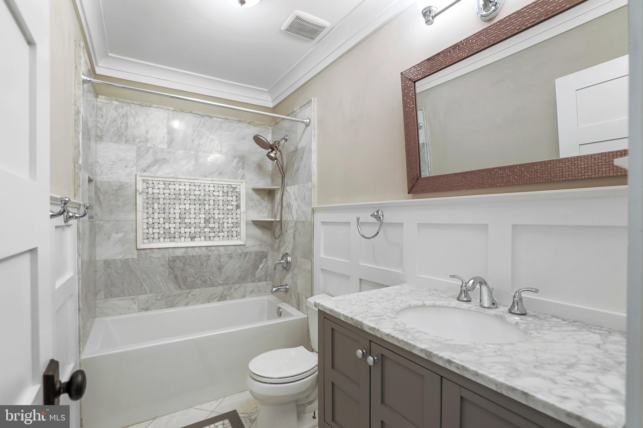 21490 Cedar Drive Sterling, VA 20164 - Photo 36 of 73 a bathroom with a granite countertop sink a toilet and bathtub