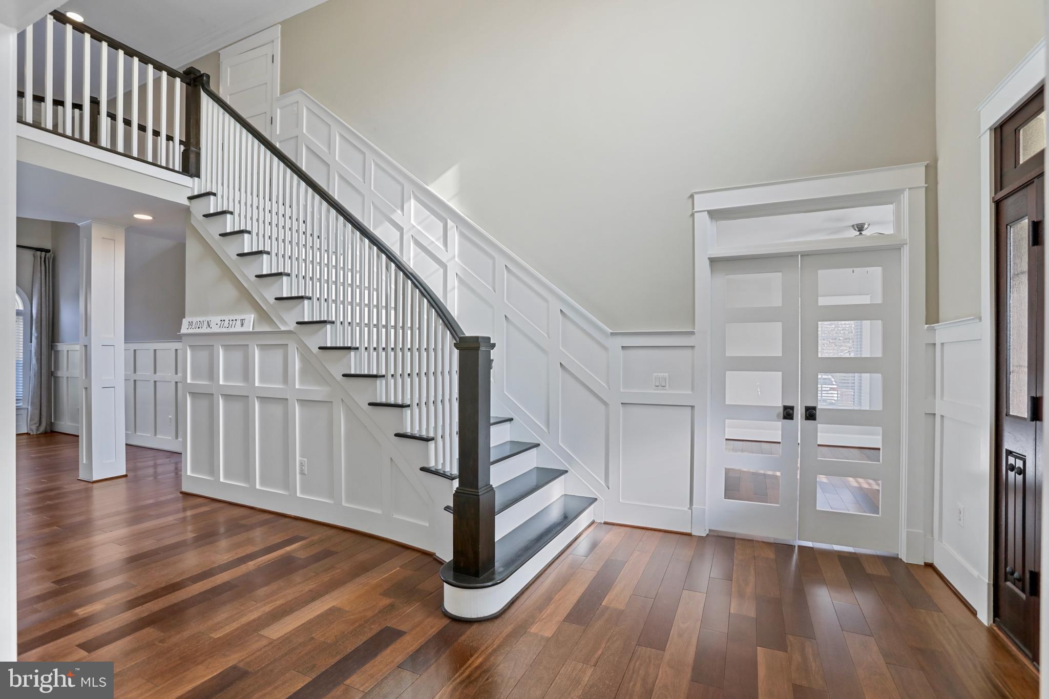 21490 Cedar Drive Sterling, VA 20164 - Photo 5 of 73 a view of a hallway with wooden floor staircase and a living room