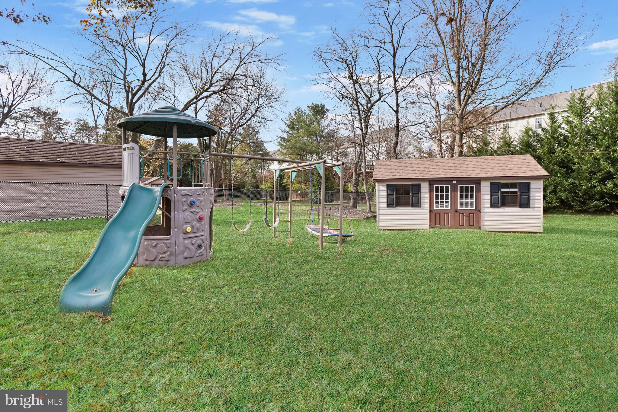 21490 Cedar Drive Sterling, VA 20164 - Photo 54 of 73 a view of a house with a yard patio and fire pit