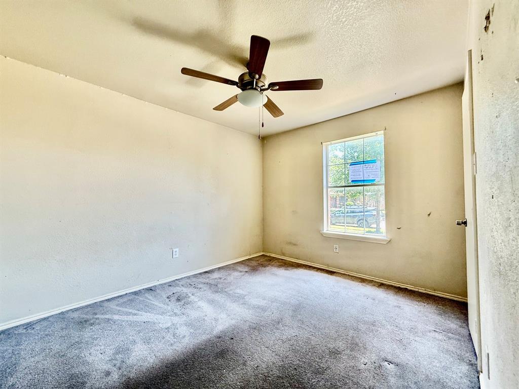 1144 Switchgrass Lane Crowley, TX 76036 - Photo 7 of 17 an empty room with ceiling fan and window