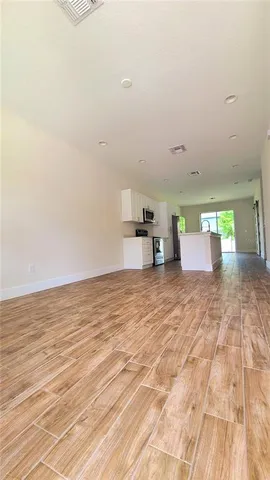 a view of a room with wooden floor