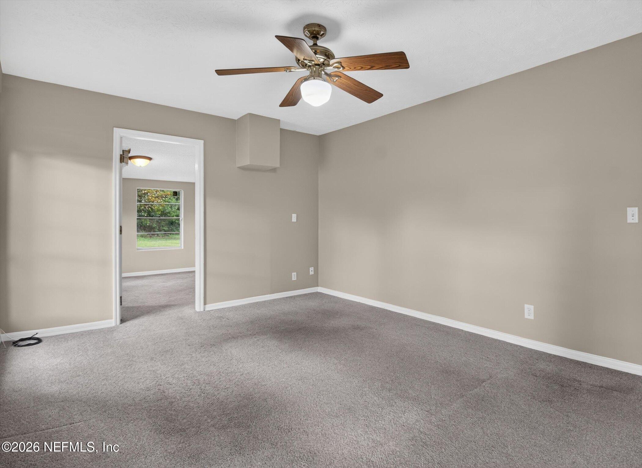 2705 Navajo Road Orange Park, FL 32073 - Photo 37 of 58 an empty room and chandelier fan