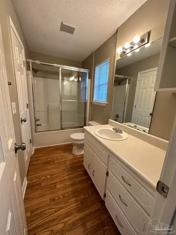 a bathroom with a double vanity sink mirror and shower