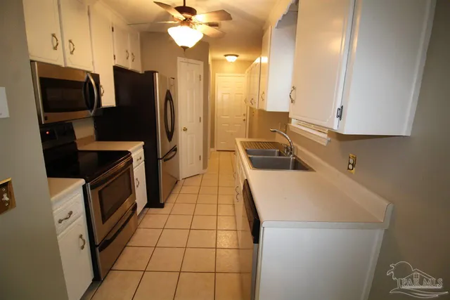 a kitchen with a sink appliances and cabinets