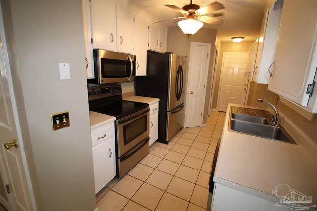 a kitchen with stainless steel appliances a refrigerator sink and microwave
