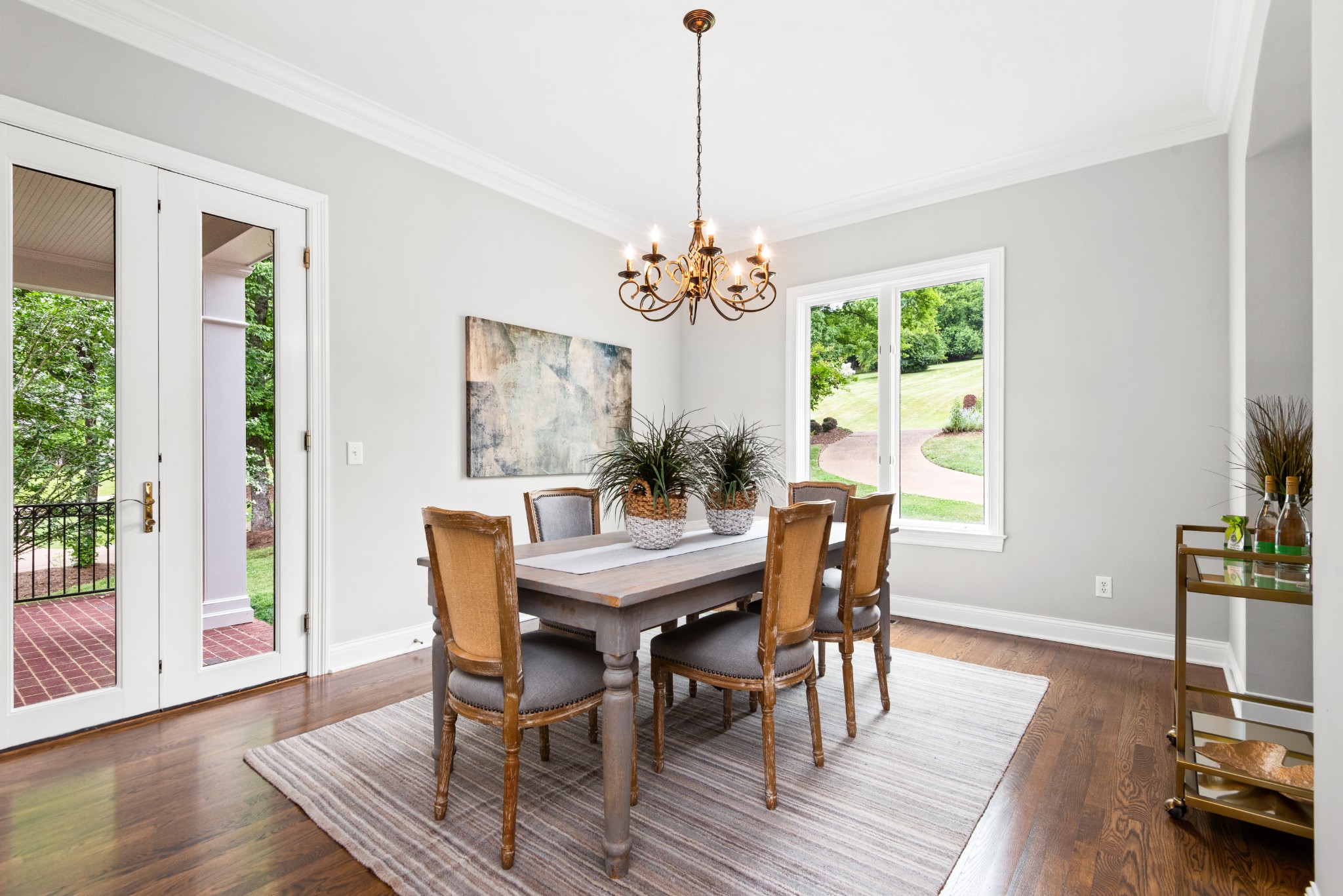 697 Legends Crest Drive Franklin, TN 37069 - Photo 4 of 26 a dining room with wooden floor a chandelier a wooden table and chairs