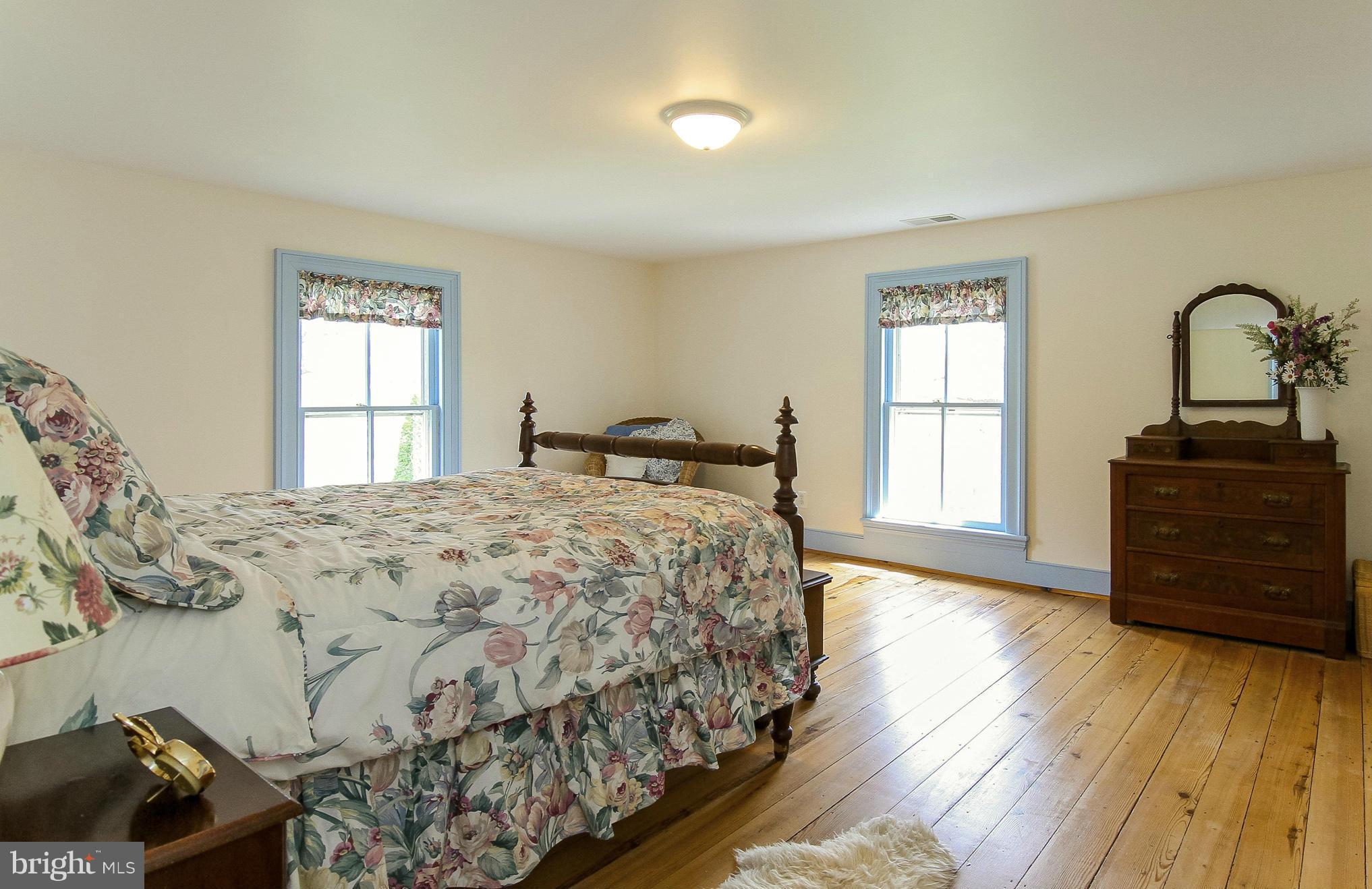 8735 Monumental Mills Road Rixeyville, VA 22737 - Photo 15 of 25 a bedroom with a bed and wooden floor