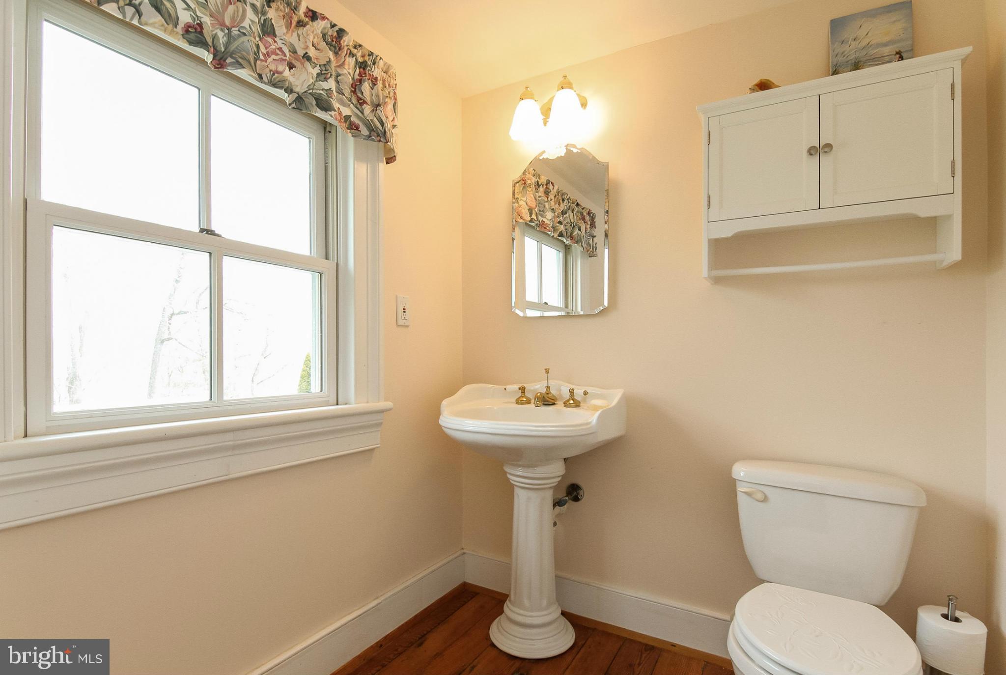 8735 Monumental Mills Road Rixeyville, VA 22737 - Photo 17 of 25 a bathroom with a toilet sink and mirror