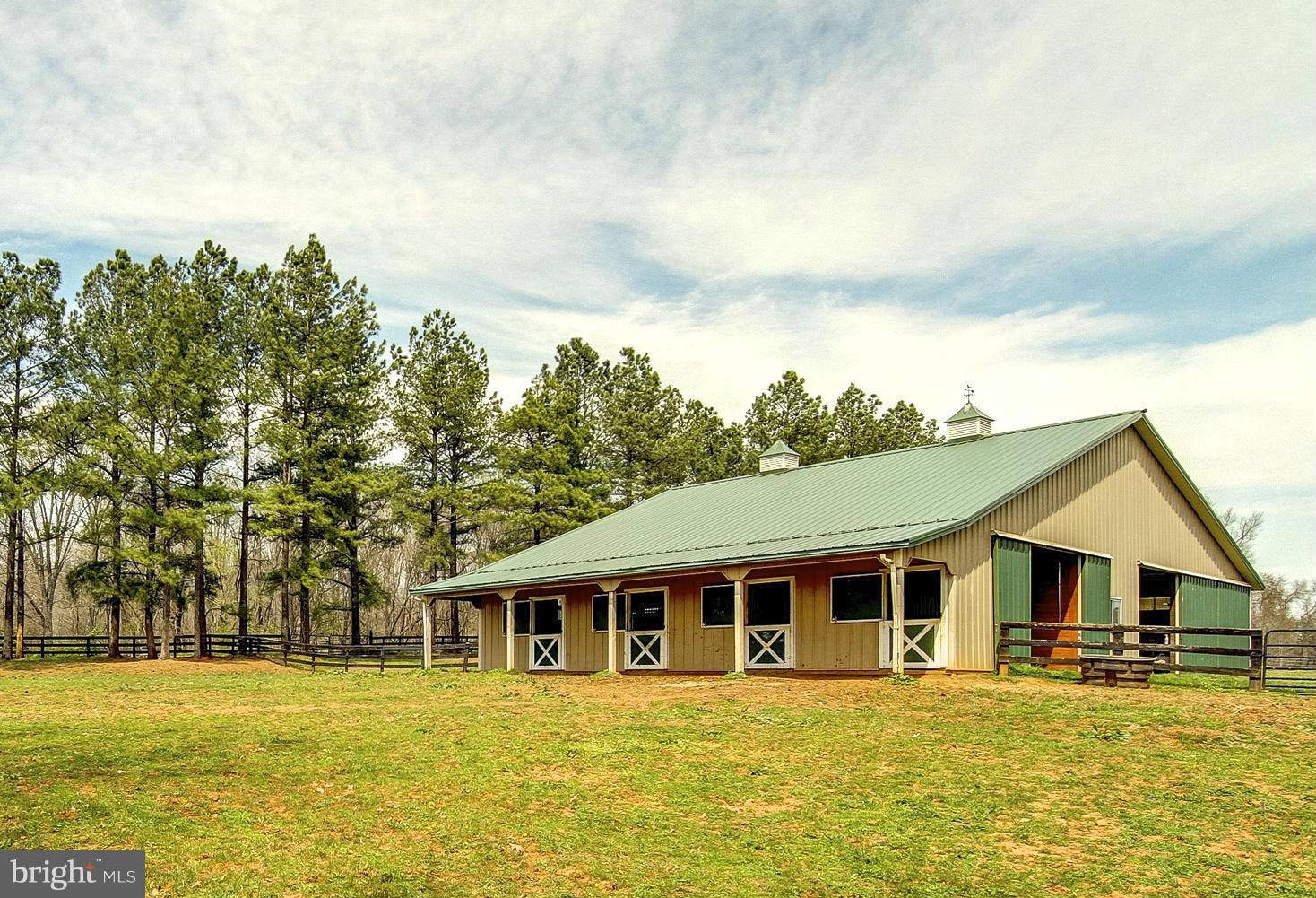 8735 Monumental Mills Road Rixeyville, VA 22737 - Photo 19 of 25 a front view of a house with swimming pool and trees in the background
