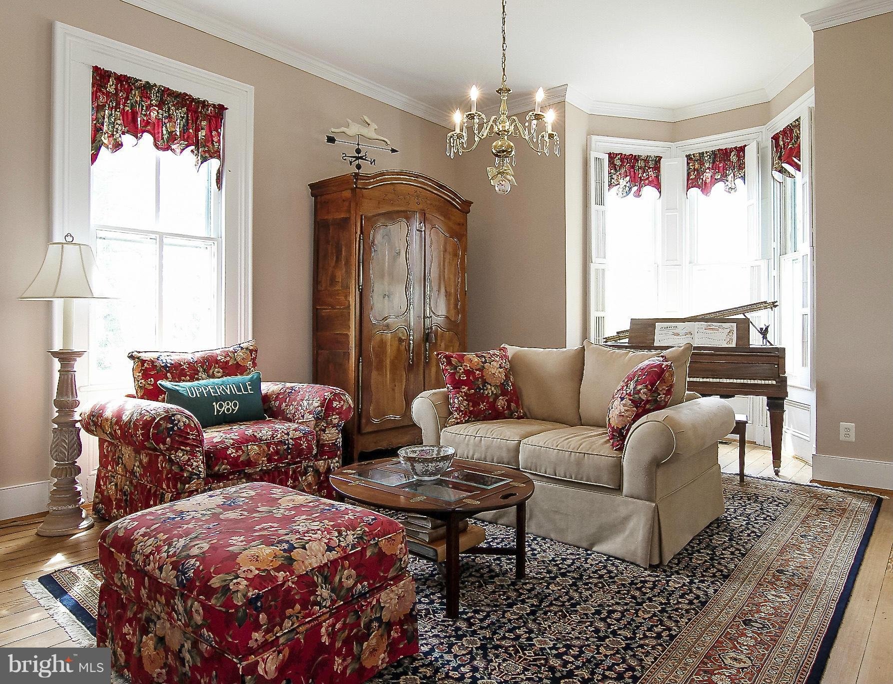 8735 Monumental Mills Road Rixeyville, VA 22737 - Photo 3 of 25 a living room with furniture a chandelier and a window