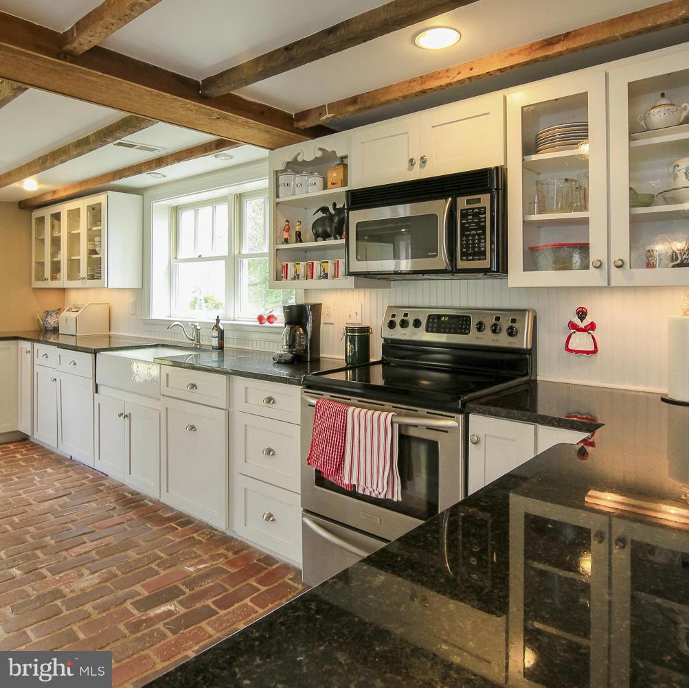 8735 Monumental Mills Road Rixeyville, VA 22737 - Photo 8 of 25 a kitchen with stainless steel appliances granite countertop a sink and cabinets
