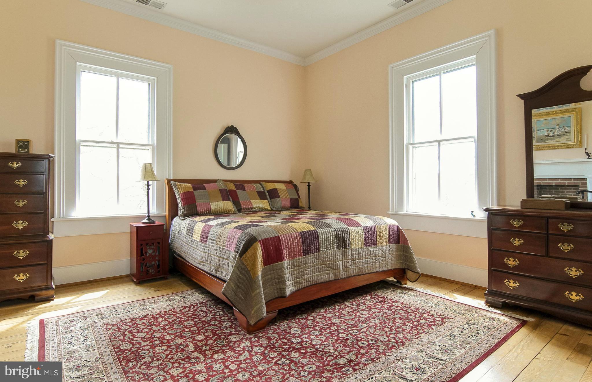 8735 Monumental Mills Road Rixeyville, VA 22737 - Photo 9 of 25 a bedroom with a large bed and a window