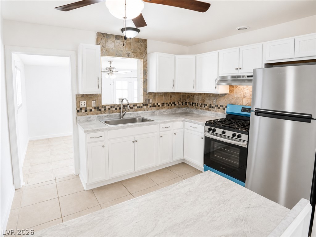2870 South Sandhill Road Las Vegas, NV 89121 - Photo 39 of 64 A well-appointed kitchen showcasing white cabinetry and practical appliances for daily culinary needs.