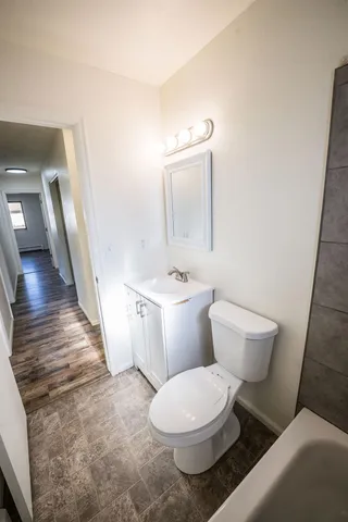 a view of a room with wooden floor and white doors