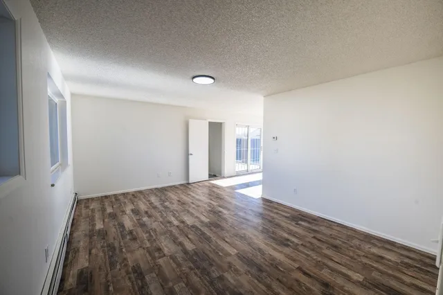 a view of room with window and wooden floor