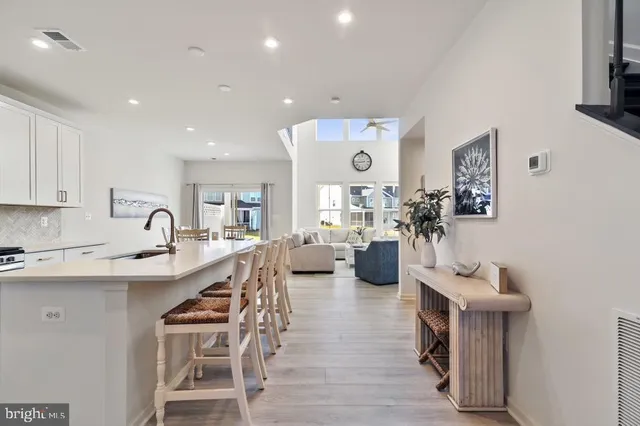 a living room with furniture and kitchen view