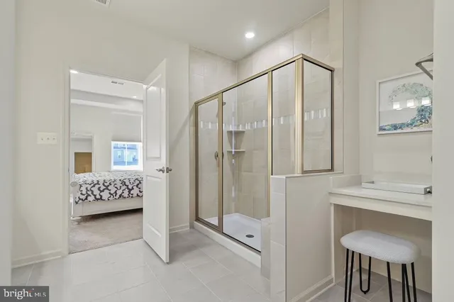 a spacious bathroom with a glass shower door and a mirror