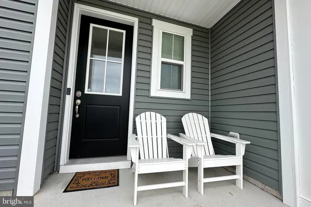 a view of two chairs in back of the house