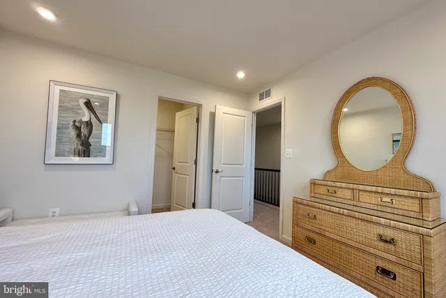 a bedroom with a bed and a dresser