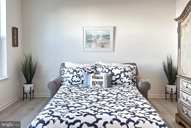 a bedroom with a large bed and a lamp