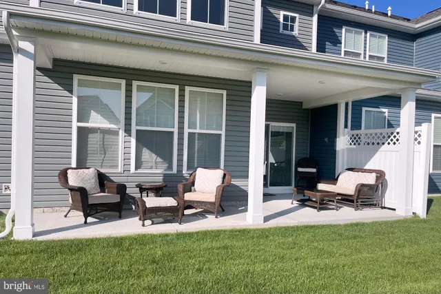 a view of a patio with table and chairs