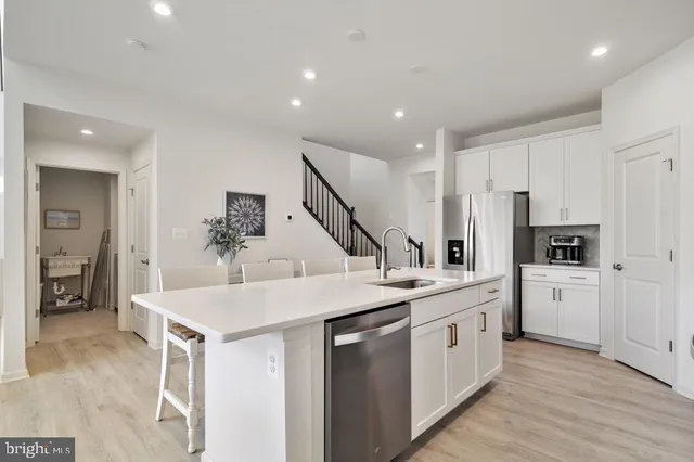 a kitchen with a sink and white cabinets