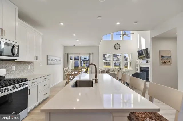 a large kitchen with stainless steel appliances granite countertop a lot of counter space and a sink