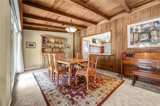 a dining room with furniture a rug and wooden floor