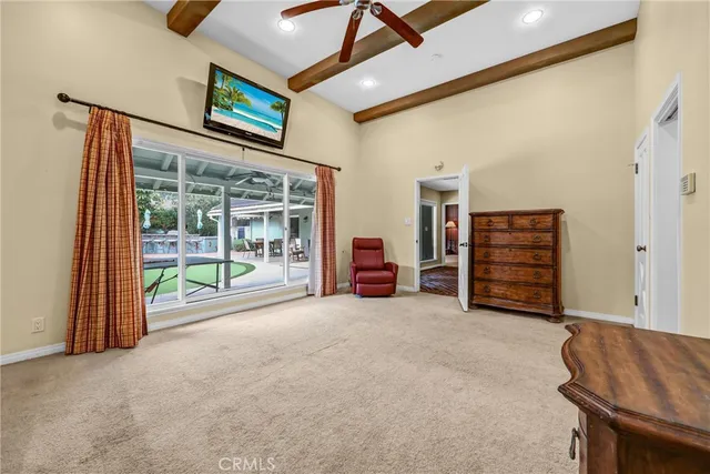 a view of an empty room with furniture and a ceiling fan